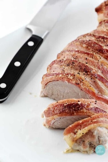 Bacon Wrapped Pork Tenderloin Recipe from addapinch.com
