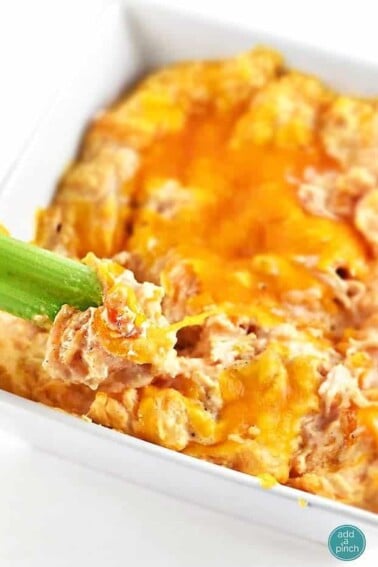 Buffalo Chicken Dip tastes just like the buffalo chicken we all love. This creamy buffalo chicken dip comes together easily and is always a winner! // addapinch.com