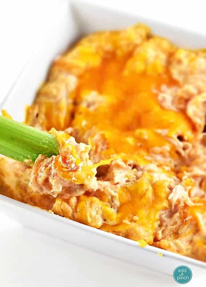 Buffalo Chicken Dip tastes just like the buffalo chicken we all love. This creamy buffalo chicken dip comes together easily and is always a winner! // addapinch.com