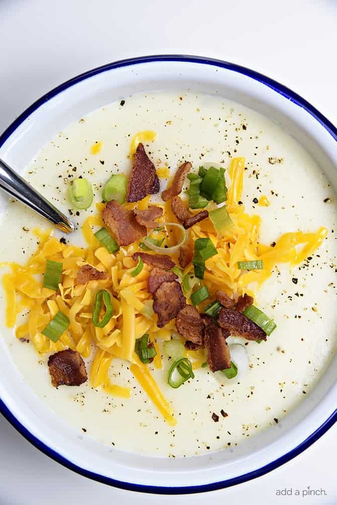 Loaded Baked Potato Soup Recipe - Loaded baked potato soup makes a warm, comforting potato soup recipe. Made with baked potatoes blended into a creamy soup and topped with your potato bar favorites! // addapinch.com