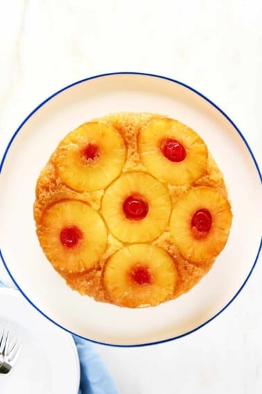 Homemade pineapple upside down cake with brown sugar topping of pineapples and studded with cherries.