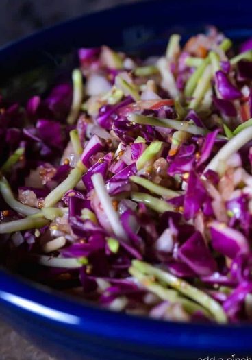 Asian Slaw Recipe. This Asian slaw recipe is quick, easy and so full of flavor. Perfect for a weeknight side dish or even when entertaining! // addapinch.com