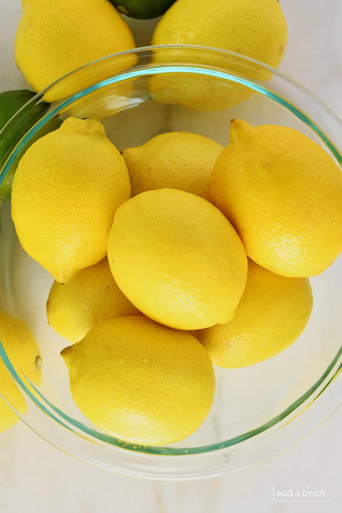 Glass bowl full of lemons.