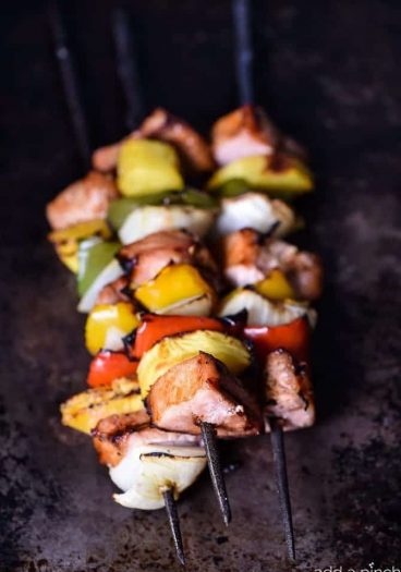 These easy grilled pork tenderloin and pineapple skewers are a quick-fix family favorite! Ready in minutes and so delicious! // addapinch.com