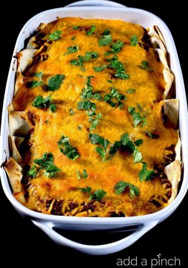 This easy beef and bean enchilada recipe comes together quickly for a delicious recipe perfect for a weeknight supper! // addapinch.com