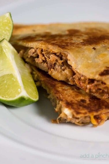 Pulled pork quesadillas make an all-time favorite leftover makeover the whole family loves! So simple and easy! // addapinch.com