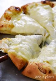 A simple recipe for homemade three cheese pizza that takes ordinary cheese pizza to a whole new level! // addapinch.com