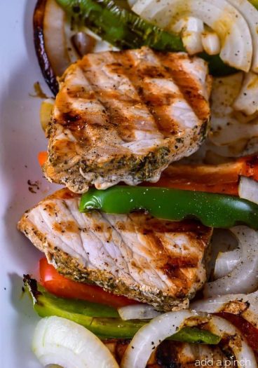 Grilled Pork Loin with Peppers and Onions makes a quick and easy dish perfect for weeknight or weekend meals! // addapinch.com