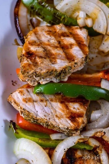 Grilled Pork Loin with Peppers and Onions makes a quick and easy dish perfect for weeknight or weekend meals! // addapinch.com