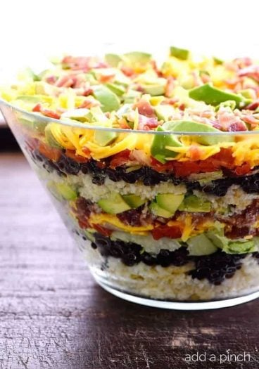 Mexican Cornbread Salad makes a delicious layered salad recipe using spicy Mexican cornbread, beans, tomatoes, and so much more! // addapinch.com