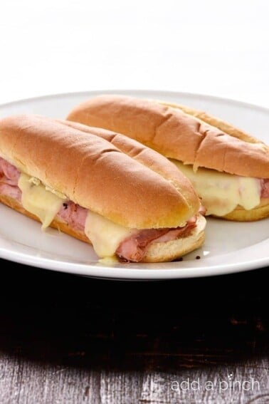 Hot Ham and Cheese Sandwiches Recipe -These simple ham sandwiches are perfect for a quick lunch or supper. Made of ham, cheese, spices, olive oil and vinegar, this isn't just any ham sandwich! // addapinch.com