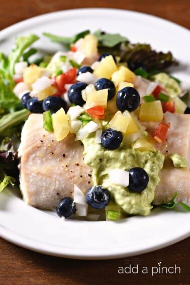Baked Mahi Mahi with Pineapple Blueberry Salsa makes a delicious, quick and easy meal perfect for a weeknight supper or entertaining! // addapinch.com