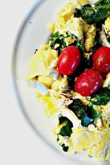 Eggs Spinach and Tomato Scramble Recipe makes a quick and delicious breakfast or brunch! // addapinch.com