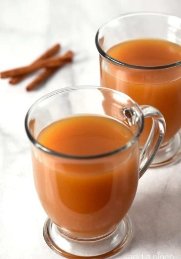 Caramel Apple Cider makes a delicious drink throughout the year, but especially during fall and winter! This quick and easy recipe gives instructions for a single mug, a half gallon, as well as slow cooker instructions! It is a MUST have recipe! // addapinch.com