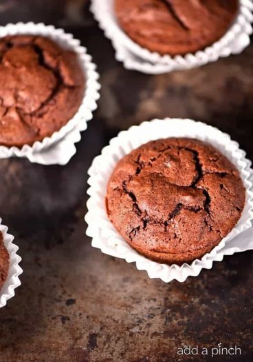 Pumpkin Chocolate Chocolate Chip Muffins make a special treat for breakfast, brunch or an afternoon snack! These are a definite fall favorite! // addapinch.com