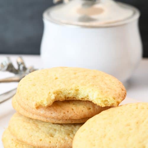 Photograph of stack of teacake cookies on a white platter. // addapinch.com
