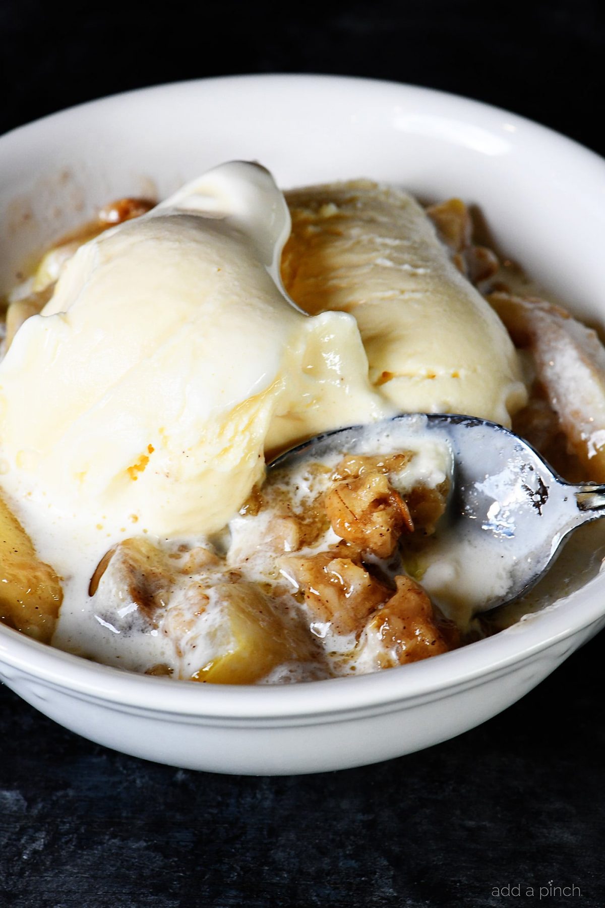 photograph of dessert with vanilla ice cream in a white bowl. 