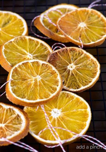 How to Make Dried Orange Slices - Dried Orange Slices make great additions to floral arrangements, wreaths and as Christmas ornaments. // addapinch.com