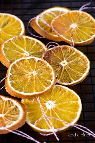 How to Make Dried Orange Slices - Dried Orange Slices make great additions to floral arrangements, wreaths and as Christmas ornaments. // addapinch.com