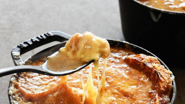 French Onion Soup makes a comforting, classic bowl of soup! Made with caramelized onions a slice of crusty bread and melty, delicious cheese! Includes stovetop and slow cooker methods! // addapinch.com