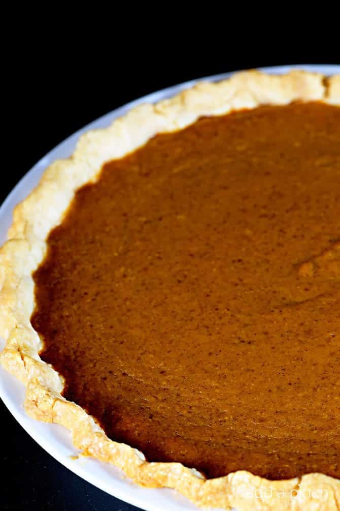 This classic pumpkin pie recipe makes an old fashioned pie perfect for serving during the holidays or anytime! So easy and delicious, this is a family-favorite pumpkin pie! // addapinch.com