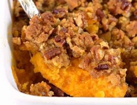 Sweet Potato Casserole topped with pecan streusel in white baking dish