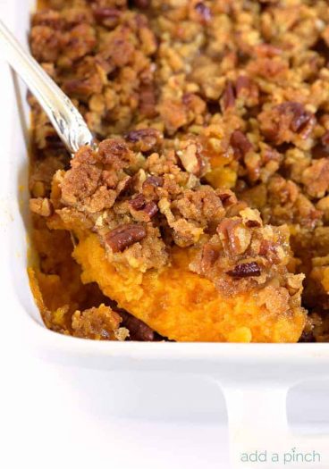 Sweet Potato Casserole topped with pecan streusel in white baking dish