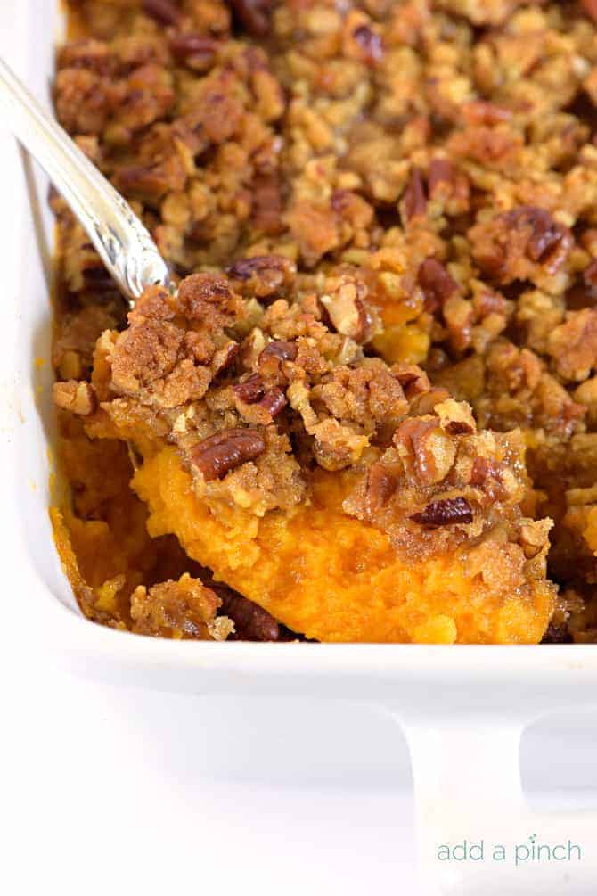 Sweet Potato Casserole is a southern classic. With a rich, buttery taste and crunchy topping, sweet potato casserole makes a perfect side dish or a dessert. // addapinch.com