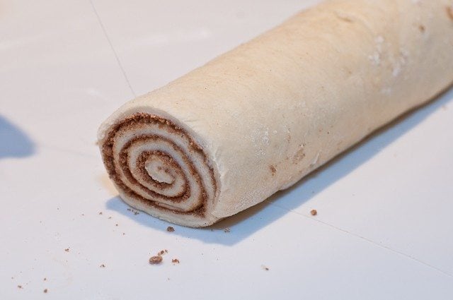 Long roll of  cinnamon roll dough before it is cut into individual rolls // addapinch.com