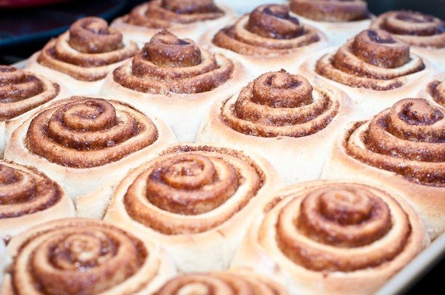 Freshly baked Cinnamon Rolls with no icing on baking sheet - // addapinch.com