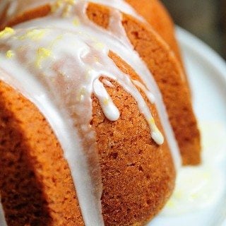 Side view of lemon pound cake with lemon buttermilk glaze drizzled on top.