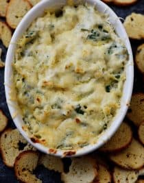 This Hot Spinach Artichoke Dip is so quick and easy! Made of just six ingredients and ready in less than 30 minutes, this spinach artichoke dip is a favorite! // addapinch.com