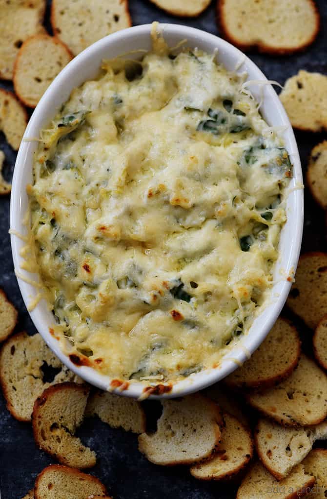 This Hot Spinach Artichoke Dip is so quick and easy! Made of just six ingredients and ready in less than 30 minutes, this spinach artichoke dip is a favorite! // addapinch.com