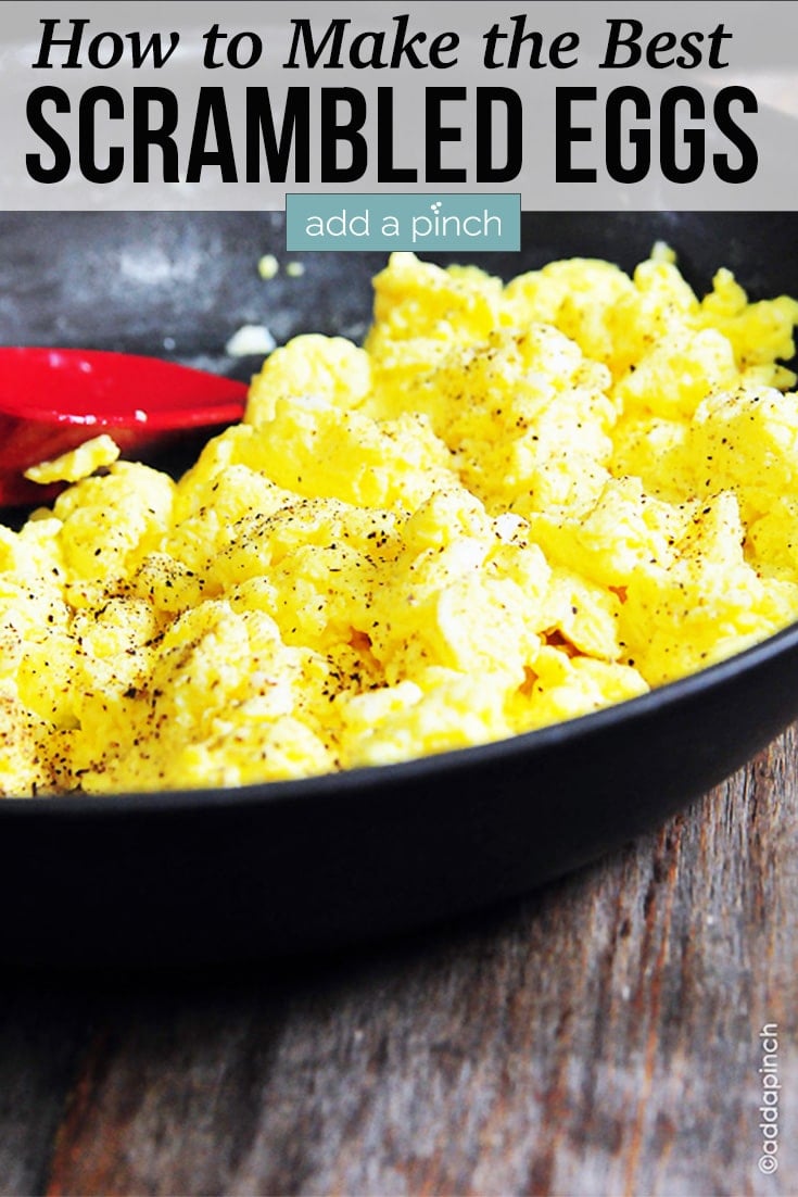 Scrambled Eggs sprinkled with salt and pepper in a cast iron skillet - with text - addapinch.com