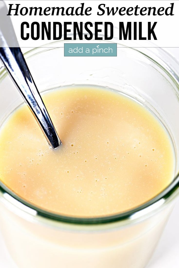 Glass jar of Homemade Sweetened Condensed Milk with spoon - with text - addapinch.com