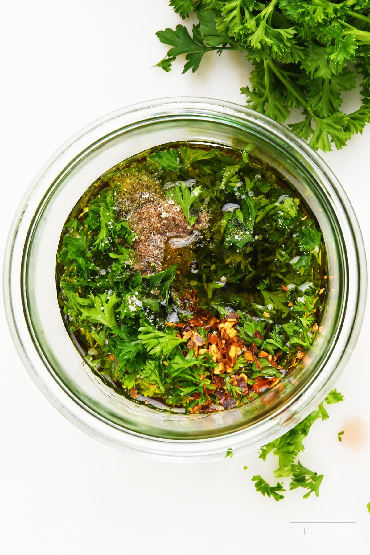 Resting chimichurri sauce recipe in a glass container.