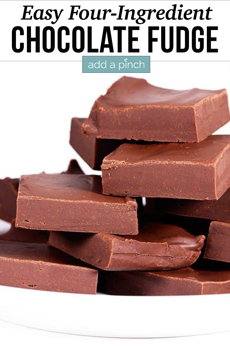 Stack of pieces of Easy Chocolate Fudge on white serving dish - with text - addapinch.com