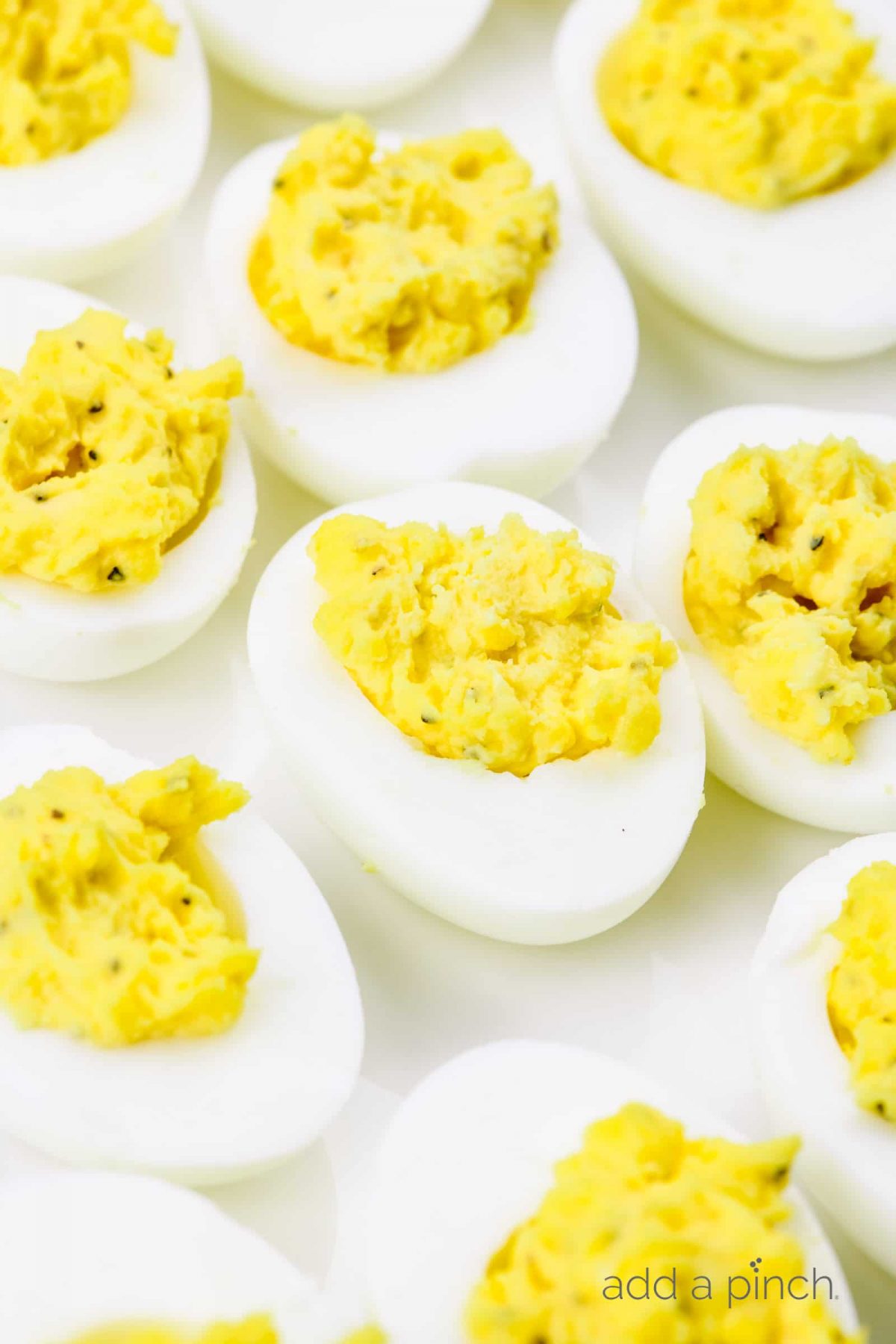 Deviled eggs make the perfect appetizer or side dish for family meals, parties, holidays, potlucks, picnics and more. This simple and classic deviled eggs recipe is a family favorite! // addapinch.com