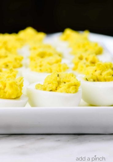 Deviled eggs make the perfect appetizer or side dish for family meals, parties, holidays, potlucks, picnics and more. This simple and classic deviled eggs recipe is a family favorite! // addapinch.com