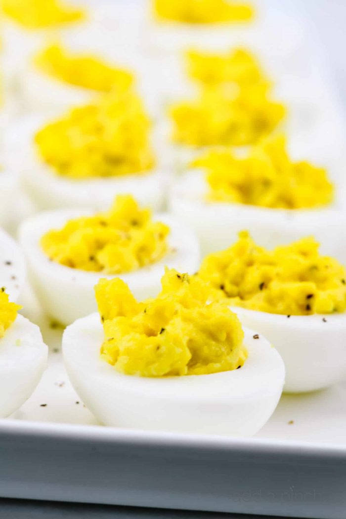 Deviled eggs make the perfect appetizer or side dish for family meals, parties, holidays, potlucks, picnics and more. This simple and classic deviled eggs recipe is a family favorite! // addapinch.com