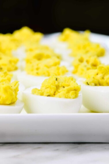 Deviled eggs make the perfect appetizer or side dish for family meals, parties, holidays, potlucks, picnics and more. This simple and classic deviled eggs recipe is a family favorite! // addapinch.com