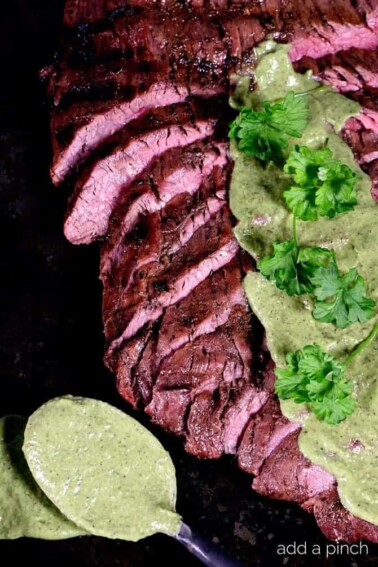 Grilled Flank Steak Recipe - Flank Steak is a long, relatively thin cut of beef that when cooked properly practically melts in your mouth! Served with a chimichurri sauce, this flank steak is a definite favorite! // addapinch.com