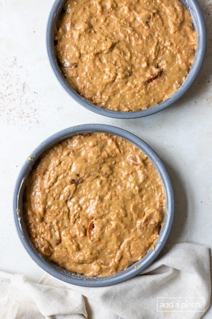 Photo of carrot cake batter in two cake pans.