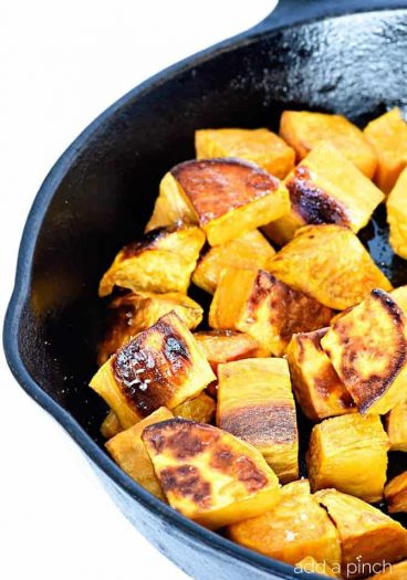 Skillet roasted sweet potatoes make a favorite side dish! Made with just a few ingredients, the skillet makes these sweet potatoes incredibly crisp, yet still tender. // addapinch.com