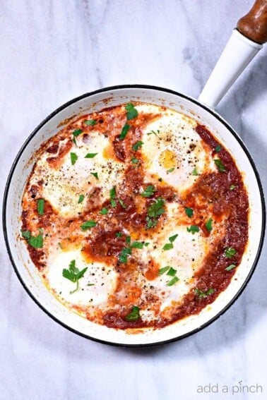 Eggs in Purgatory Recipe - Eggs in Purgatory makes a simple, yet spicy dish for breakfast, brunch, or even a cozy supper. Ready and on the table in less than 30 minutes! // addapinch.com