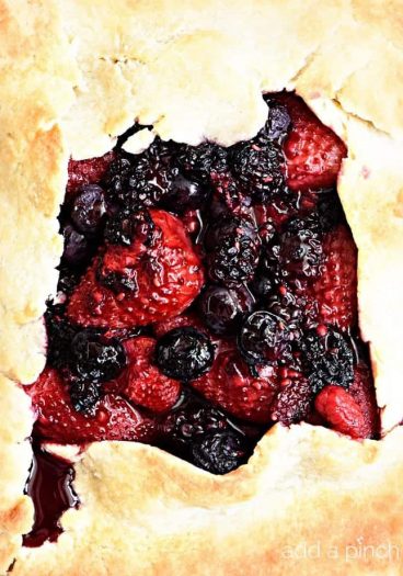 Rustic Mixed Berry Tart Recipe - This Rustic Mixed Berry Tart recipe makes a delicious dessert recipe perfect for a simple weeknight supper! Made of strawberries, blueberries and blackberries and sweetened with honey. So easy! // addapinch.com