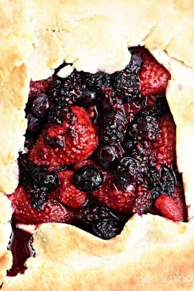 Rustic Mixed Berry Tart Recipe - This Rustic Mixed Berry Tart recipe makes a delicious dessert recipe perfect for a simple weeknight supper! Made of strawberries, blueberries and blackberries and sweetened with honey. So easy! // addapinch.com