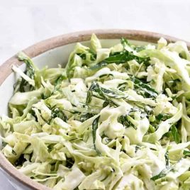 Cabbage and Collard Green Coleslaw Recipe - Cabbage and Collard Coleslaw makes a quick, easy and delicious coleslaw recipe! Made with fresh cabbage, collard greens, onions and a tangy dressing! // addapinch.com