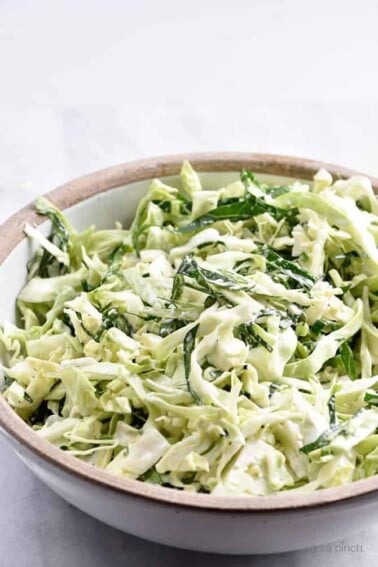Cabbage and Collard Green Coleslaw Recipe - Cabbage and Collard Coleslaw makes a quick, easy and delicious coleslaw recipe! Made with fresh cabbage, collard greens, onions and a tangy dressing! // addapinch.com