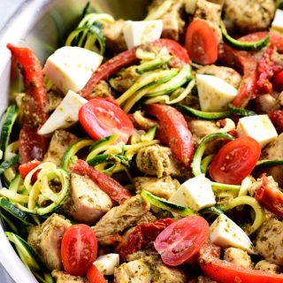 One Pan Pesto Chicken Recipe - This One Pan Pesto Chicken recipe makes a quick and easy answer to what's for supper? Made with chicken, pesto, peppers, tomatoes, zucchini and mozzarella, this will easily become a favorite! // addapinch.com
